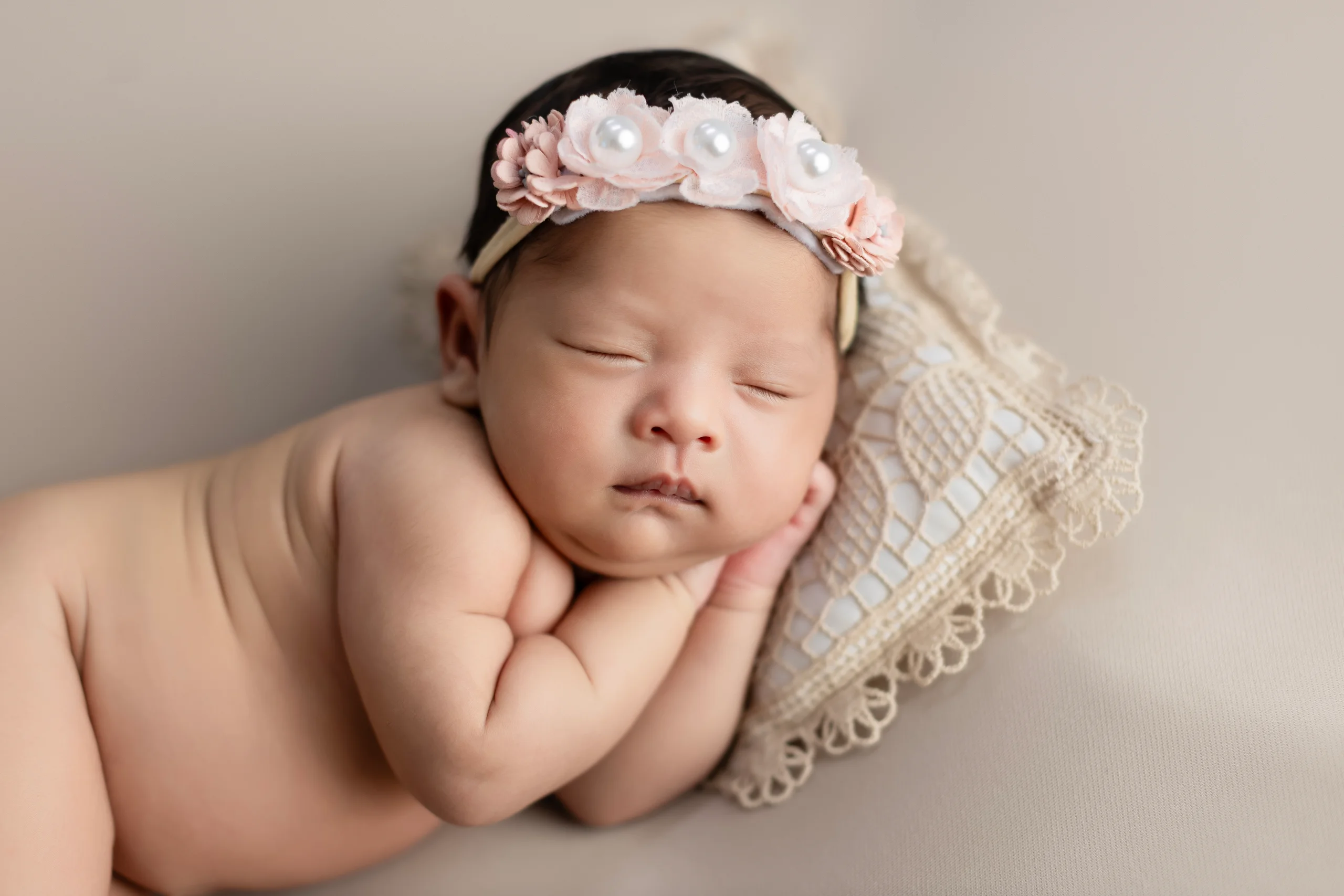 Newborn baby photography session at Cute Galleries studio in Kathmandu, Nepal — sleeping newborn wrapped in soft light